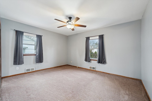 carpeted empty room featuring ceiling fan