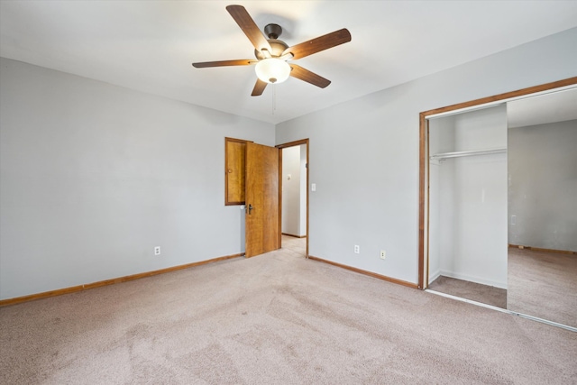 unfurnished bedroom with ceiling fan, light colored carpet, and a closet