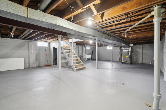 basement featuring heating unit and sink