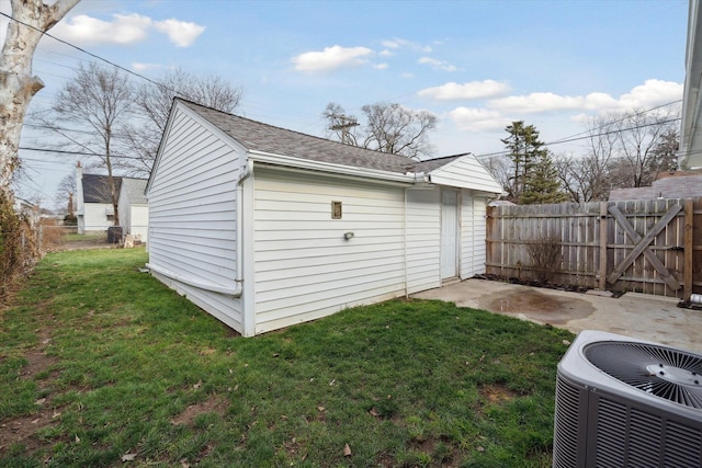 view of outbuilding featuring central AC and a lawn