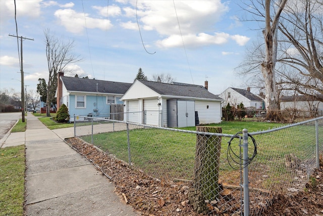 view of front of house with a garage, an outdoor structure, and a front yard