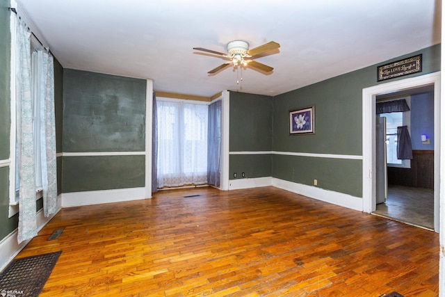 spare room featuring ceiling fan and wood-type flooring