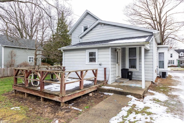 back of house with central AC unit and a deck