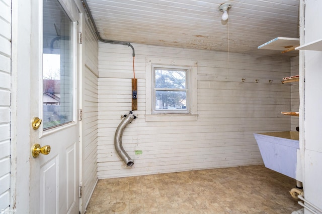 bathroom featuring wood walls