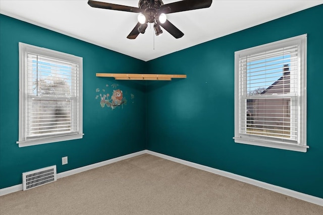 unfurnished room with ceiling fan and carpet floors