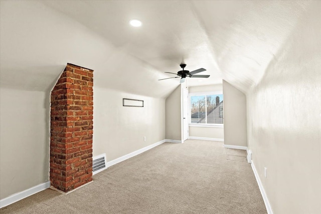 additional living space with vaulted ceiling, ceiling fan, and light colored carpet