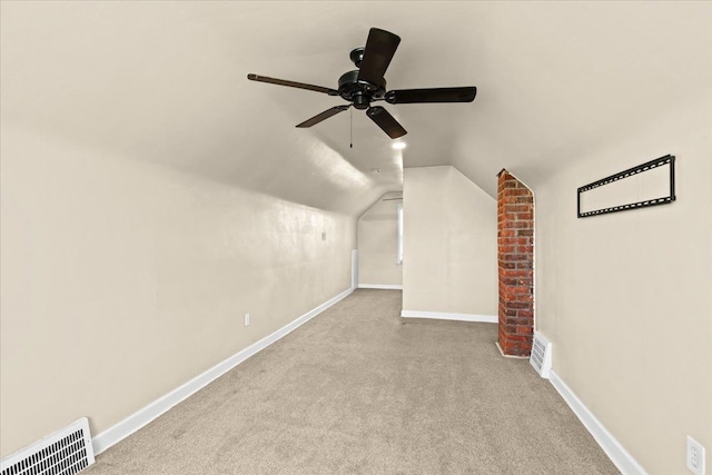 additional living space featuring vaulted ceiling, ceiling fan, and light colored carpet