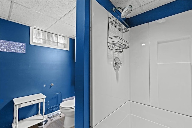 bathroom featuring toilet, a paneled ceiling, and hardwood / wood-style floors