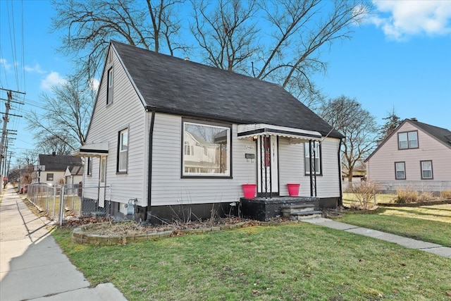 bungalow-style home with a front yard