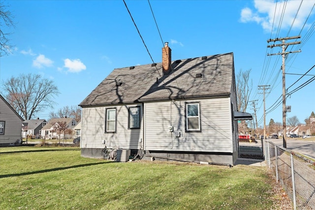 rear view of house with a lawn