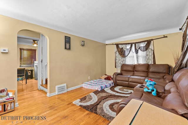 living room featuring ceiling fan and light hardwood / wood-style floors