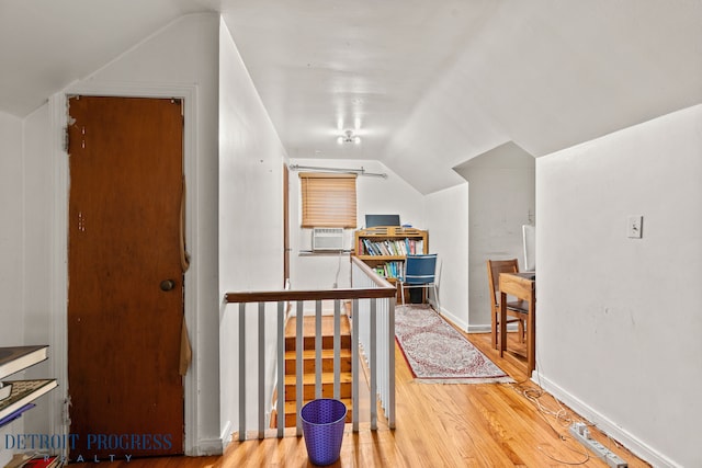 additional living space featuring hardwood / wood-style floors and lofted ceiling