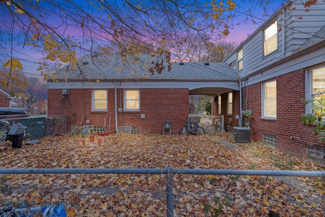 property exterior at dusk featuring central air condition unit