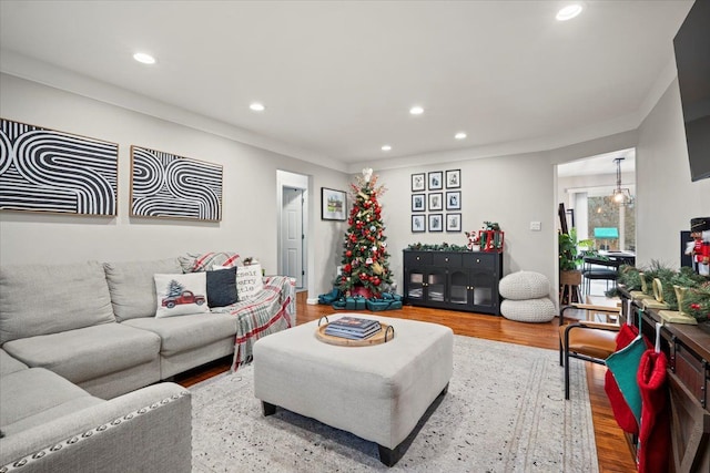 living room with ornamental molding and hardwood / wood-style flooring