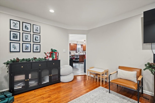 living area with hardwood / wood-style flooring