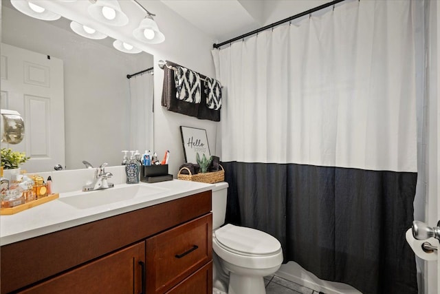 bathroom with tile patterned flooring, vanity, and toilet