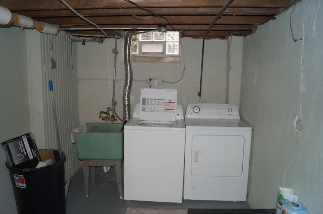 clothes washing area featuring separate washer and dryer and sink