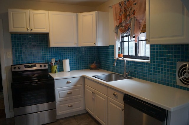 kitchen with appliances with stainless steel finishes, white cabinetry, and sink