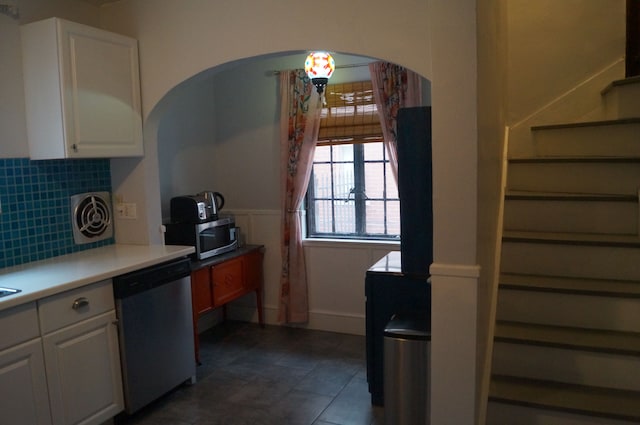 kitchen with white cabinets, appliances with stainless steel finishes, and decorative backsplash