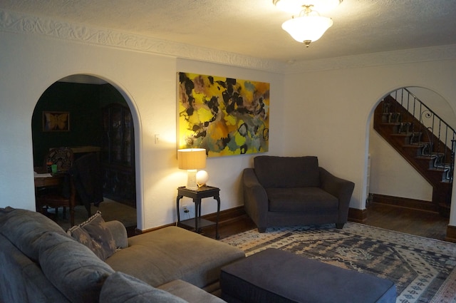 living room featuring wood-type flooring and a textured ceiling