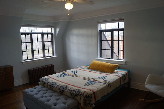 bedroom with radiator, ceiling fan, and dark wood-type flooring