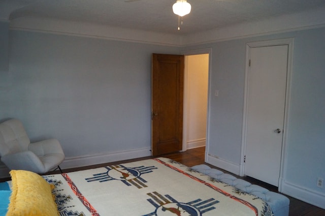 bedroom with dark wood-type flooring