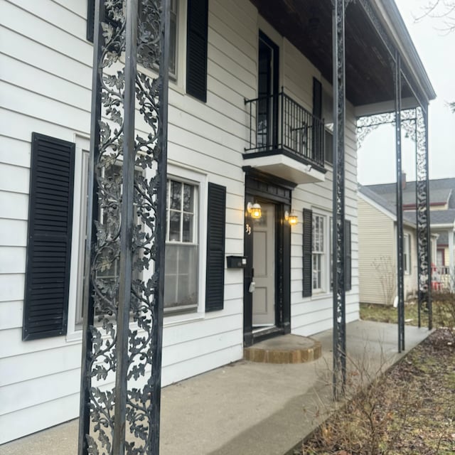 view of exterior entry featuring a balcony