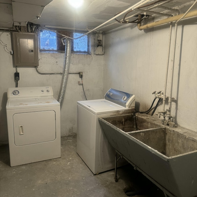 clothes washing area featuring washer and dryer, electric panel, and sink