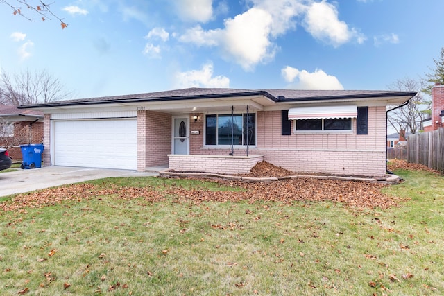 ranch-style house featuring a front lawn and a garage