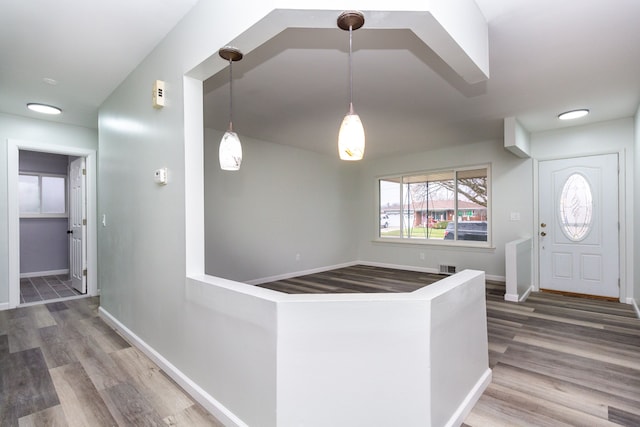 kitchen with wood-type flooring and decorative light fixtures