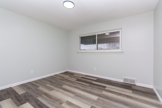 spare room with hardwood / wood-style floors