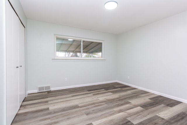 unfurnished bedroom with light hardwood / wood-style floors and a closet