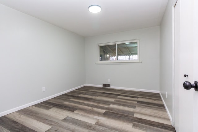 empty room featuring dark wood-type flooring