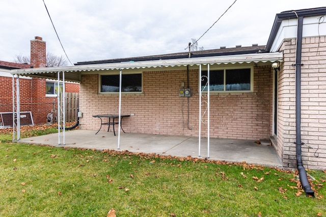 rear view of house featuring a lawn