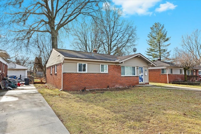 view of front of home with a garage, a front yard, and an outdoor structure