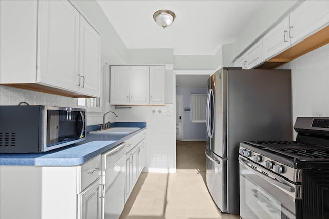 kitchen with sink, white cabinetry, and appliances with stainless steel finishes