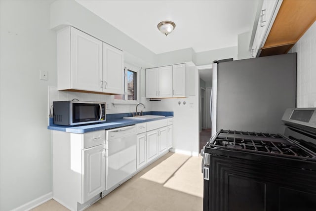 kitchen featuring sink, white cabinets, and appliances with stainless steel finishes