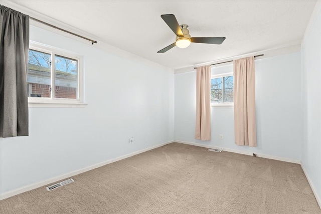 spare room with carpet floors and ceiling fan