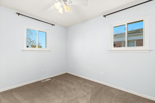 carpeted spare room with ceiling fan