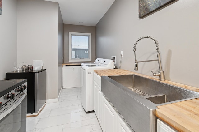 washroom featuring washing machine and dryer and sink