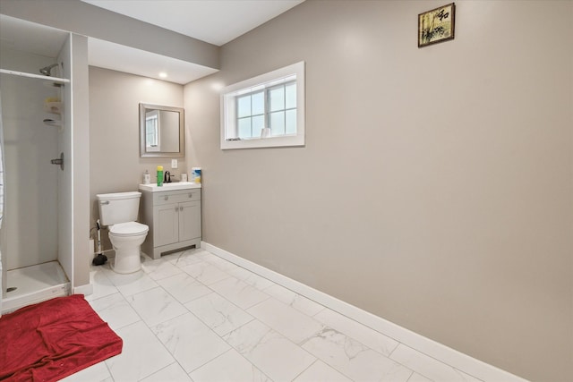 bathroom featuring vanity, toilet, and walk in shower