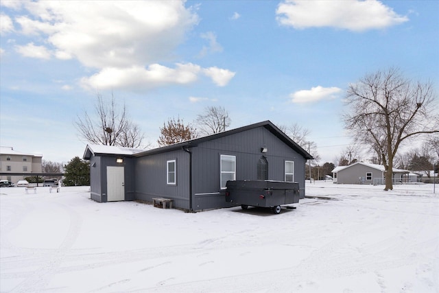 view of snow covered back of property