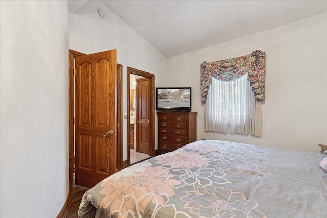 bedroom featuring lofted ceiling and hardwood / wood-style floors