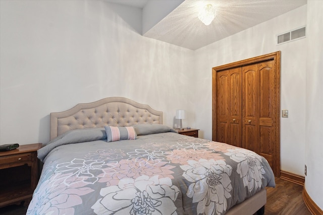 bedroom featuring dark hardwood / wood-style floors and a closet