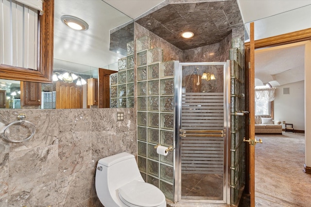 bathroom with a shower with door, tile walls, and toilet