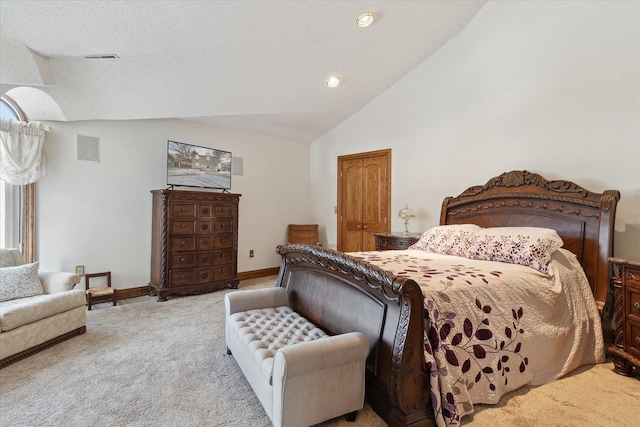 bedroom featuring lofted ceiling and light carpet