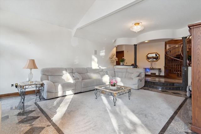 living room with lofted ceiling and decorative columns