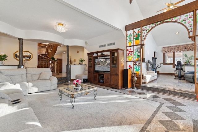 living room with decorative columns and high vaulted ceiling