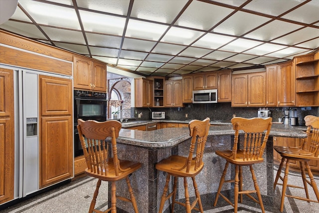 kitchen featuring sink, a kitchen breakfast bar, and kitchen peninsula