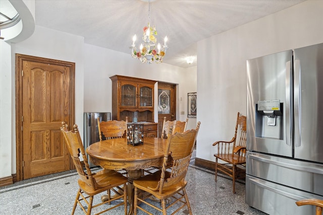 dining space featuring a textured ceiling and a notable chandelier